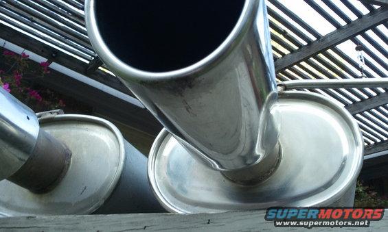 Close-up of two chrome exhaust pipes, one angled towards the camera