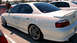 2003 Acura TL - Rear three-quarter view of a white 2003 Acura TL sedan with aftermarket wheels.