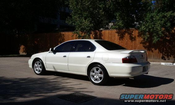 White 2003 Acura TL sedan parked outside, rear 3/4 view