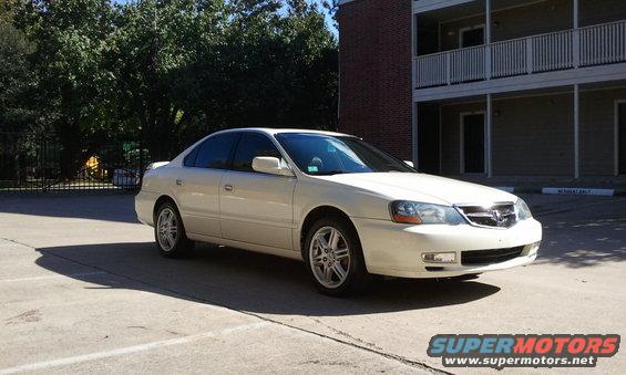 White 2003 Acura TL sedan parked outside a building