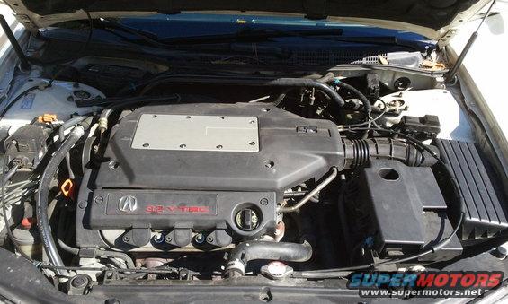Engine bay with V6 VTEC engine cover and Acura logo. Air intake system visible