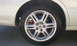 2003 Acura TL - Close-up of a white car's wheel and fender, the Acura logo on the rim.