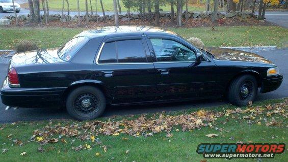 Black 1999 Ford Crown Victoria, side view
