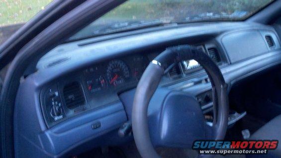 Interior shot of a 1999 Ford Crown Victoria, showing the dashboard and steering wheel