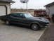 1971 Mercury Cyclone - Dark green 1971 Mercury Cyclone coupe with a hood scoop sits in a driveway.