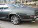 1971 Mercury Cyclone - The rear quarter panel of a 1971 Mercury Cyclone GT is visible, with its distinctive badging and chrome trim.