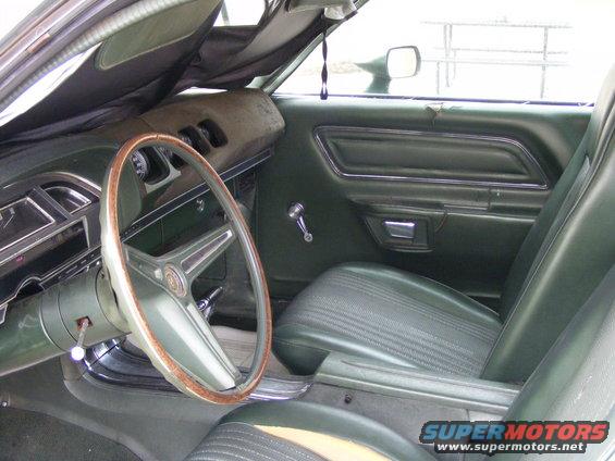 1971 Mercury Cyclone interior with green seats and wood-rimmed steering wheel