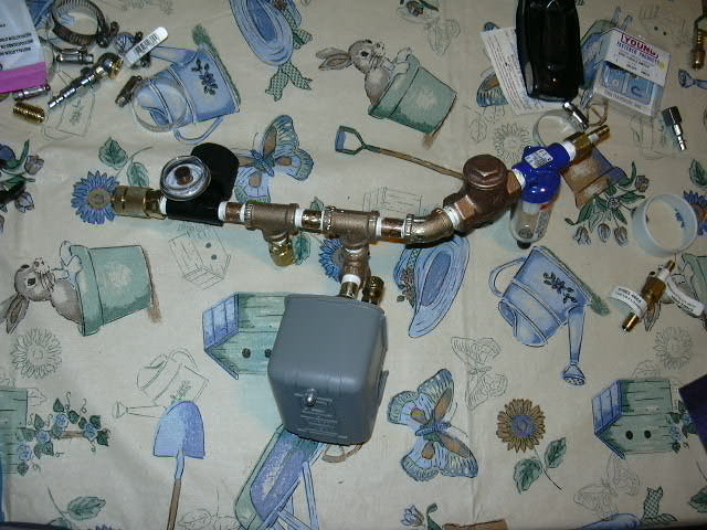 dscn0767.jpg Here it is, water/oil seperater, check valve, 90 to 125 psi switch, 150psi pop off, pressure regulator, quick disconnect.  I will run a line from this to the air storage tank still to come.