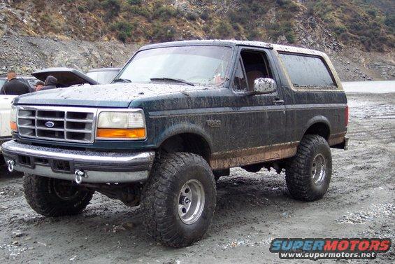 Dark green 1995 Ford Bronco with lifted suspension and large tires