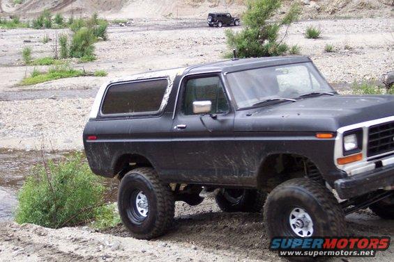Black Ford Bronco with white top, 3/4 front view