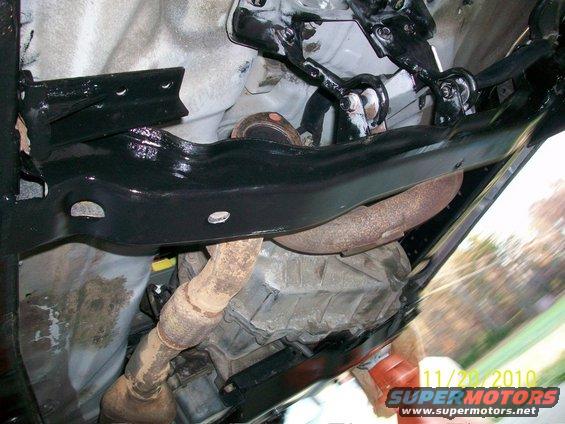 Underside view of vehicle chassis with exhaust and transmission components visible