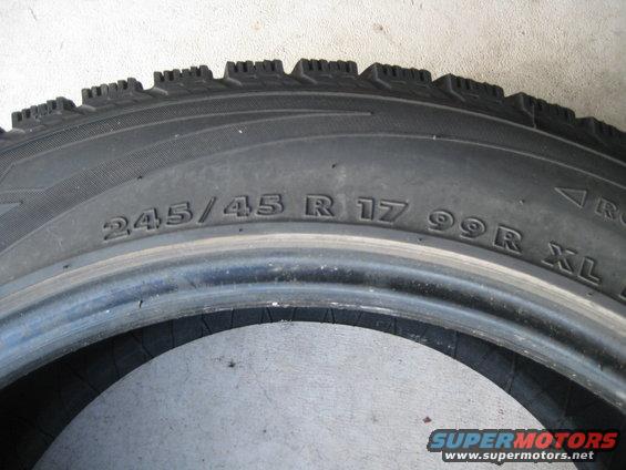 Close-up of a tire with size 245/45 R 17 99R XL printed on it