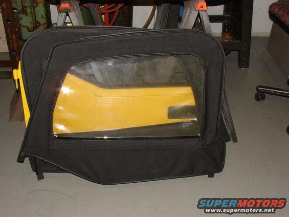 Black soft top door with a yellow interior panel visible through the plastic window