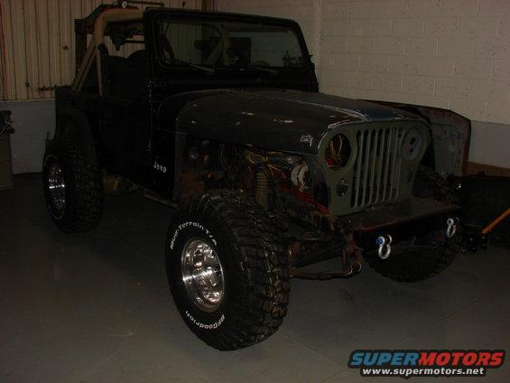 Jeep CJ-7 with front end disassembled, showing engine components and aftermarket bumper
