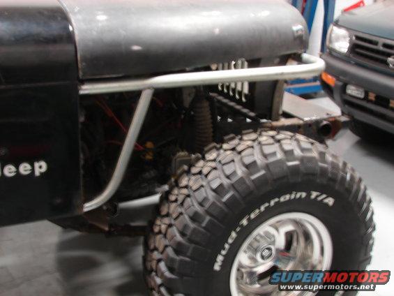 Black Jeep with large off-road tires, front view