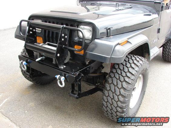 Black Jeep with winch and brush guard, front 3/4 view, off-road tires