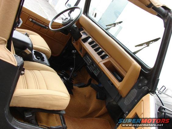 Interior of a 1993 Jeep YJ with tan seats and dashboard