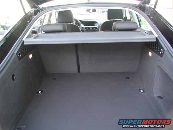 Car trunk interior with seats visible through the opening. Cargo area is empty