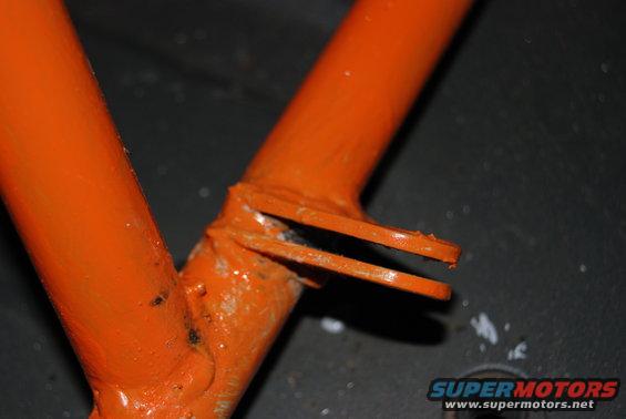 Orange painted metal frame with two prongs at the end. Supermotors.net logo visible