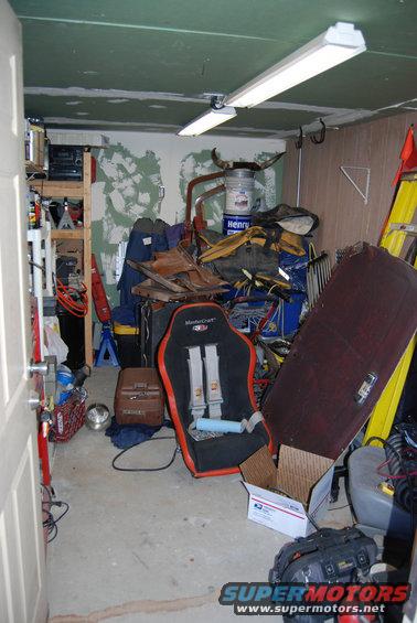 Interior scene with racing car seat, storage shelves, and a ladder