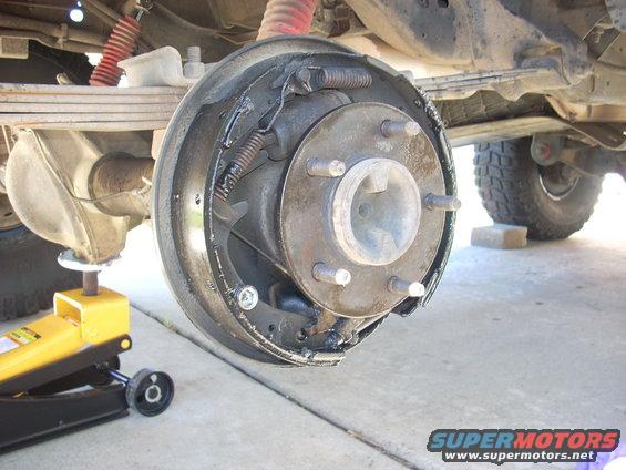 Rear drum brake assembly with yellow jack underneath