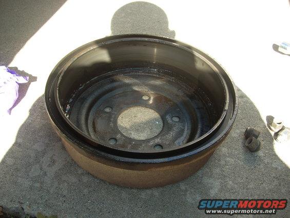 Brake drum with lug nuts on concrete