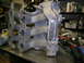 1993 Ford Probe - Intake manifold with visible welding repair on a metal workbench.