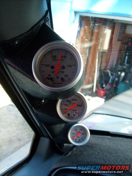 Dashboard with three gauges: volts, water temperature, and oil pressure. The volts gauge reads approximately 13.5