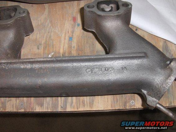 Cast iron exhaust manifold with stamped numbers 'CE H 09 10'
