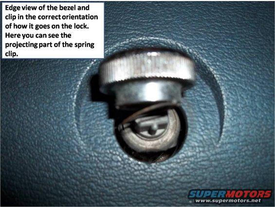 Door lock bezel and spring clip against textured blue surface