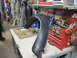 2005 Ford Excursion - A fender flare sits on a workbench in a garage setting with tools visible.