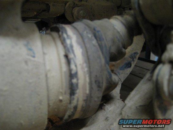 Close-up of a dirty CV joint boot on a vehicle's drivetrain