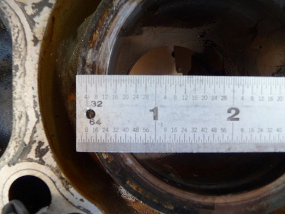 Close-up of an engine cylinder bore with a ruler measuring its diameter