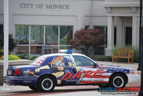 Side view of a police car with DARE graphics and cartoon characters