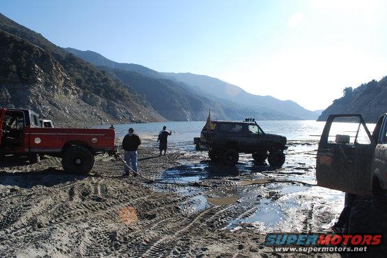 1996 Ford Bronco and red pickup truck by lake, 3q-front view