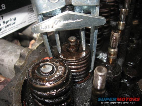 img_3155.jpg Getting the old keepers loose could be a chore on quite a few of these.  Had to tap the top of the spring compressor with a hammer to knock the spring down, while I held the valve in place with the screwdriver.  