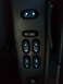 2003 Ford Crown Victoria - Close-up of illuminated power window controls on a vehicle's interior door panel.