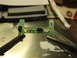2003 Ford Crown Victoria - A circuit board with electronic components is being held by two sets of tweezers.