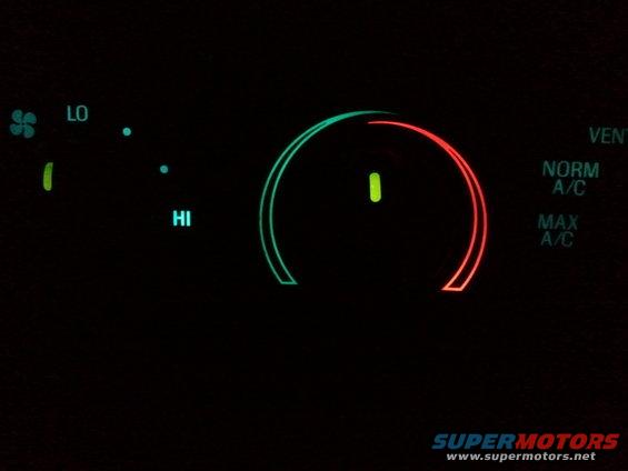 Car climate control panel with LO and HI settings, and a dial showing NORM A/C and MAX A/C