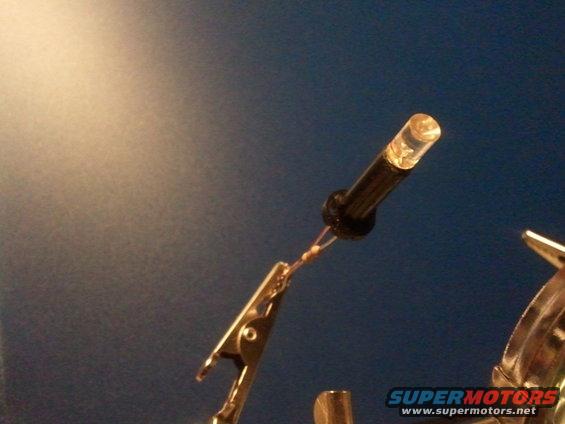 LED light with wires connected to a clip, Supermotors logo visible