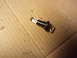 2003 Ford Crown Victoria - A light bulb assembly with a resistor is shown on a cardboard background.