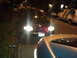 2003 Ford Crown Victoria - A 2003 Ford Crown Victoria is parked on a residential street at night with its headlights illuminated.