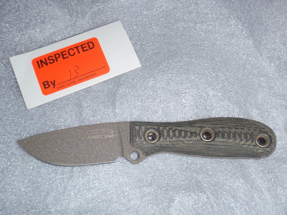 Knife with green handle and inspection sticker