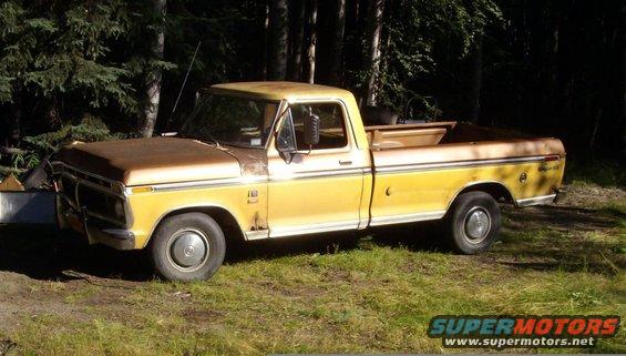 Side view of a yellow and brown 1976 Ford F-150 pickup truck parked outdoors