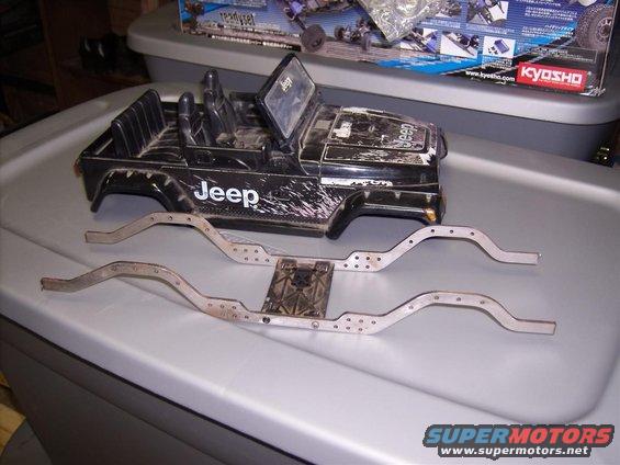 Black RC Jeep body with 'Jeep' logo and two metal chassis frames