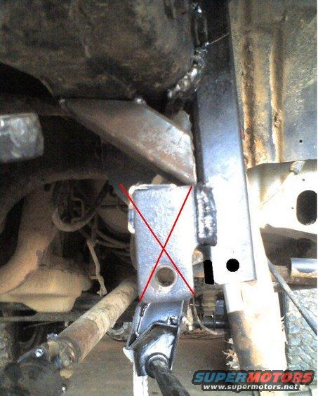 Close-up of vehicle's undercarriage, showing frame and suspension parts with red markings