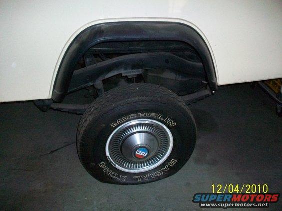 Close-up of a Jeep's rear wheel with a Michelin Radial XCH4 tire and a hubcap with a Jeep logo
