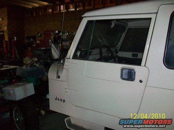 White Jeep door and side panel with 'Jeep' text, viewed from the side