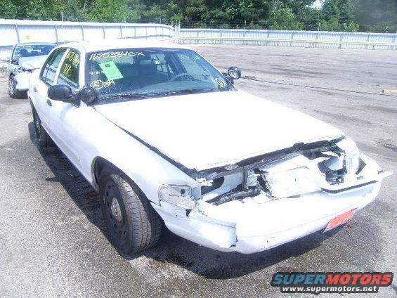 2003 Ford Crown Victoria with damaged front end, parked outdoors