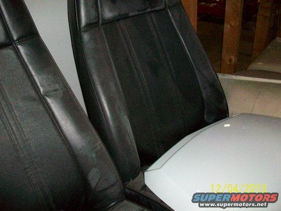 Black leather seats and white console interior